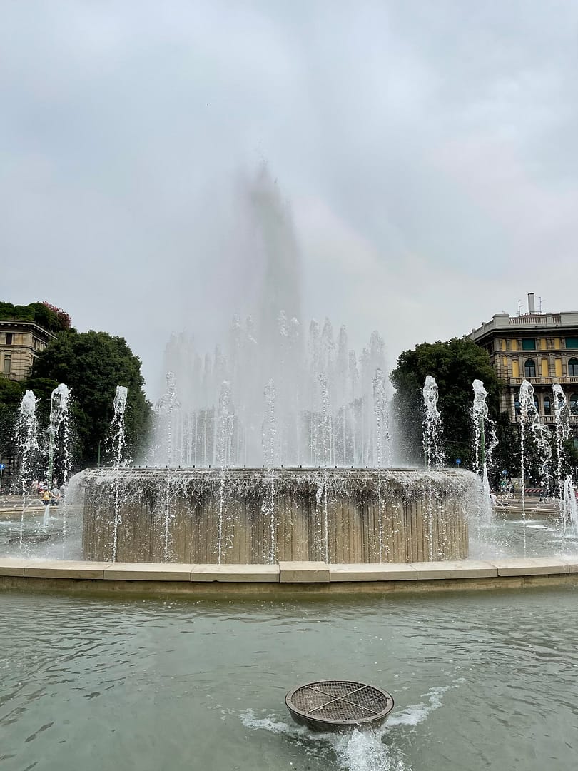 Historic fountain in the square in front of Castello Sforzesco in Milan