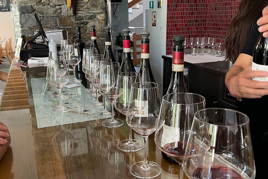 Wine glasses on the bar at Nera Vini during a Valtellina wine tour from Lake Como.