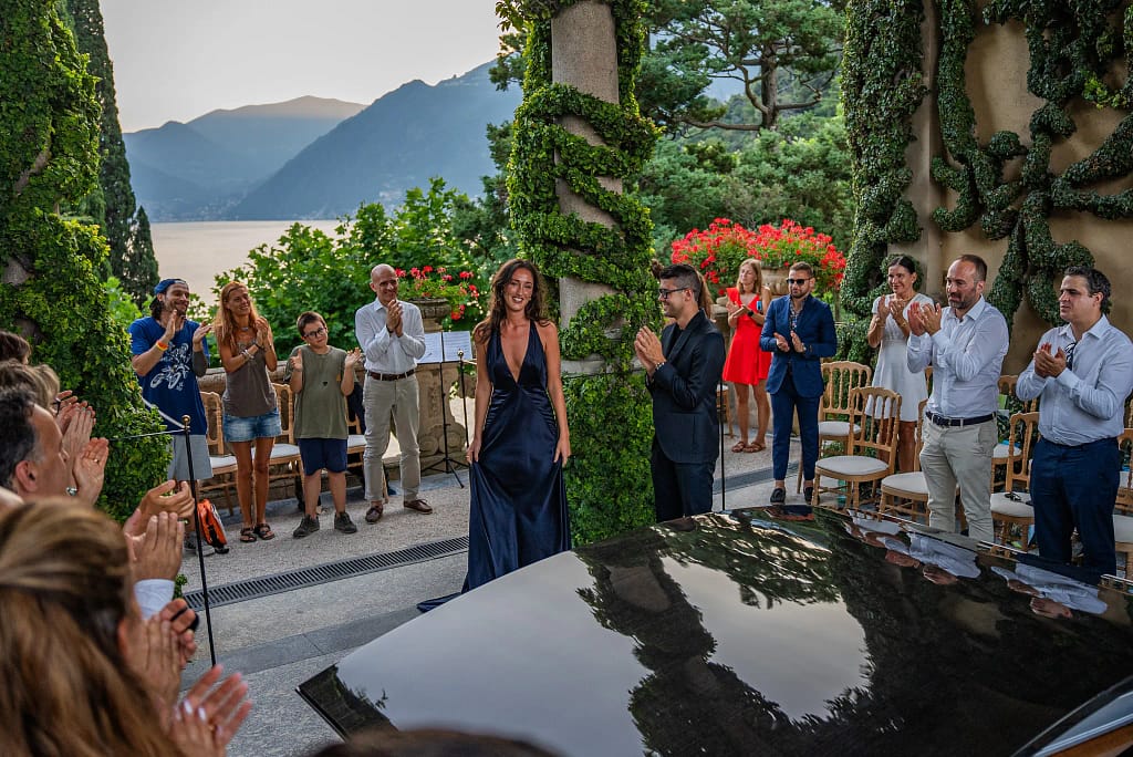 Musicians and audience at Lake Endless Joy Festival enjoying a sunset performance overlooking Lake Como.