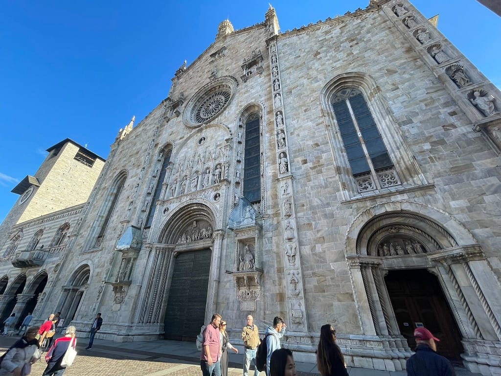 The Gothic and Renaissance facade of the Duomo di Como Cathedral in the historic center.