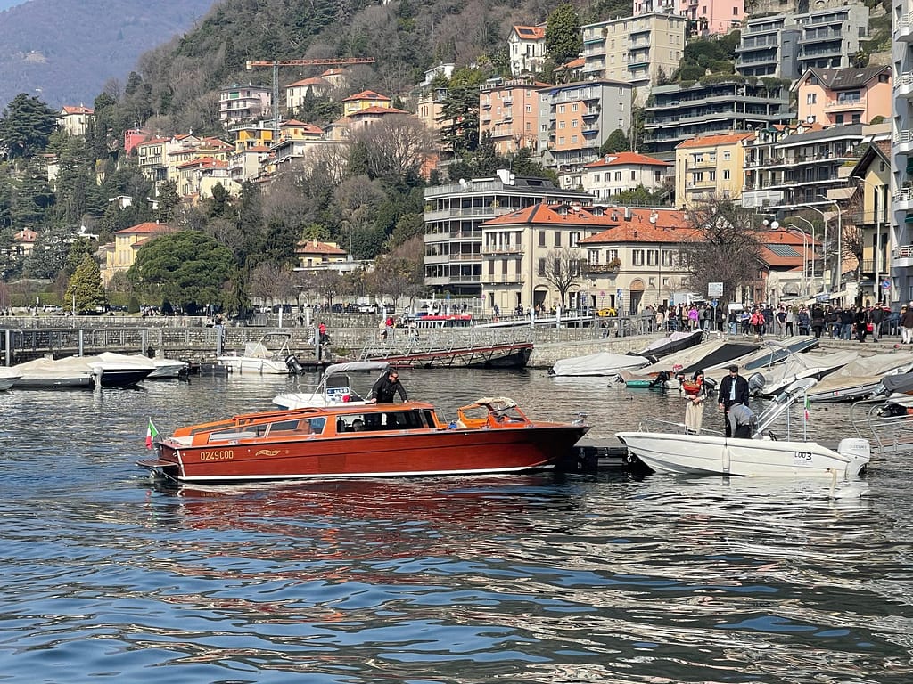Classic mahogany speedboat docked at the Como city harbor for one of the Best boat tours on Lake Como.