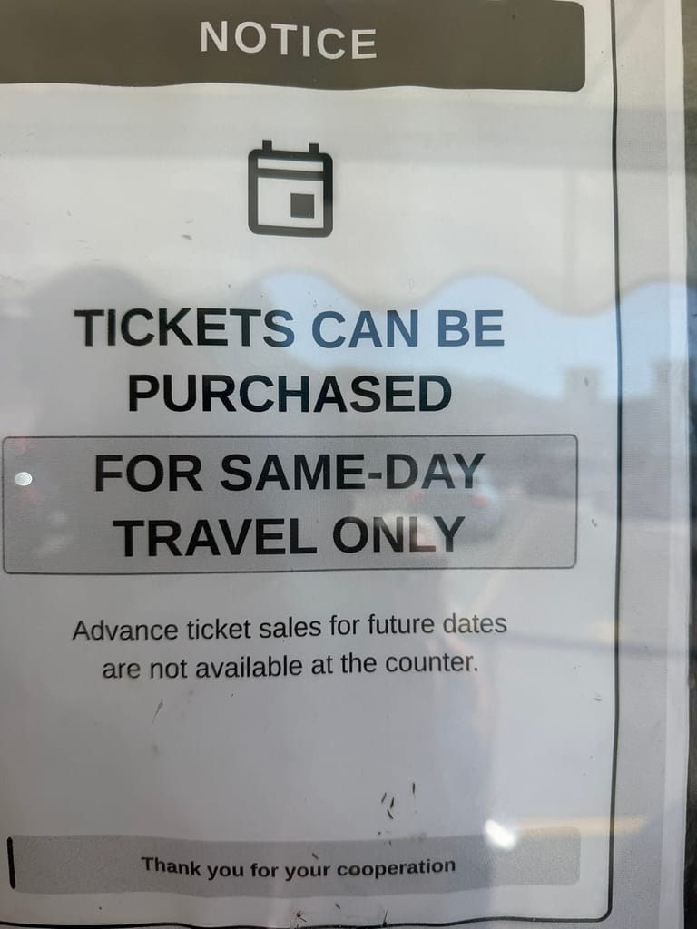 Sign at the Menaggio ferry dock stating boat tickets can only be purchased on the day of travel