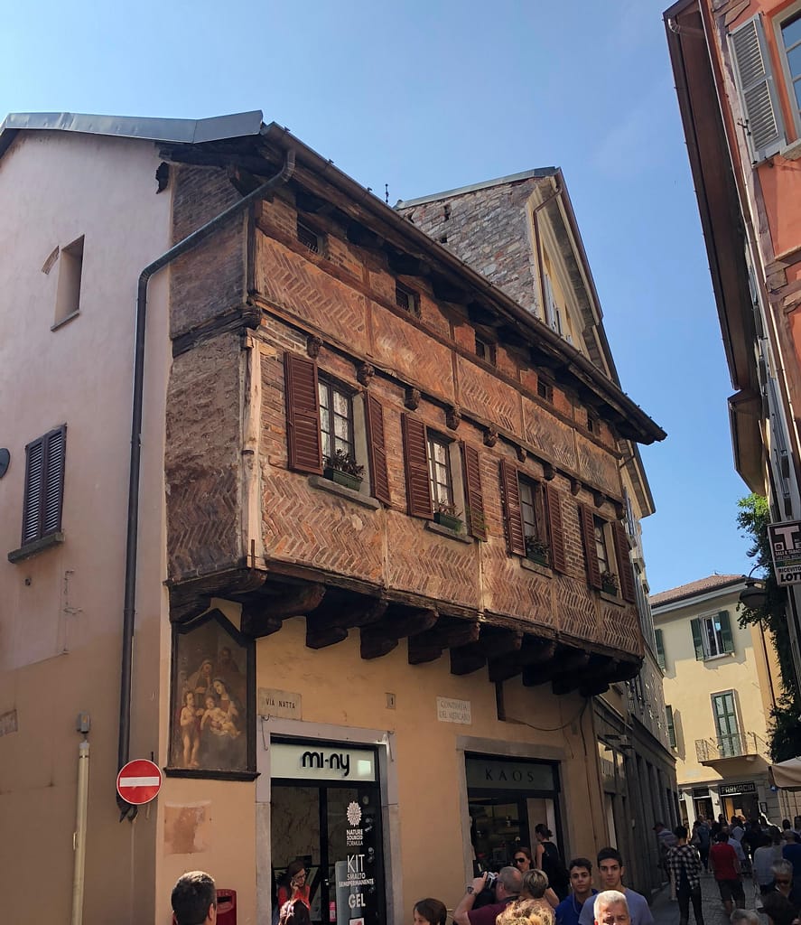 Medieval 'fishbone' style brick and wood houses overlooking Piazza San Fedele in the center of Como, Italy
