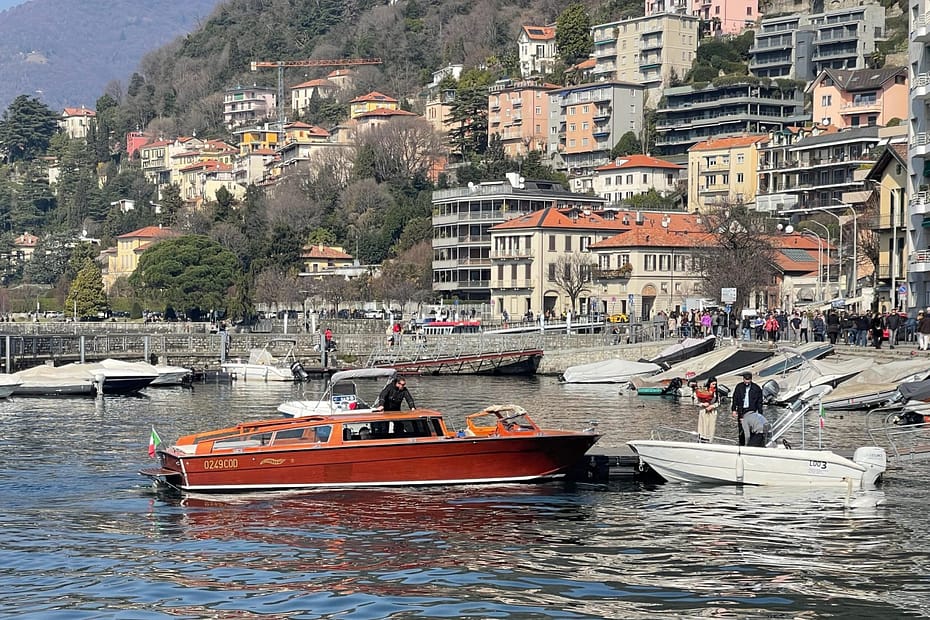Classic mahogany speedboat docked at the Como city harbor for a private Lake Como boat tour.